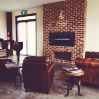 A lounge with leather armchairs at the cellar door