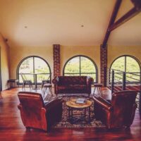 The members' lounge with leather sofas and arched windows